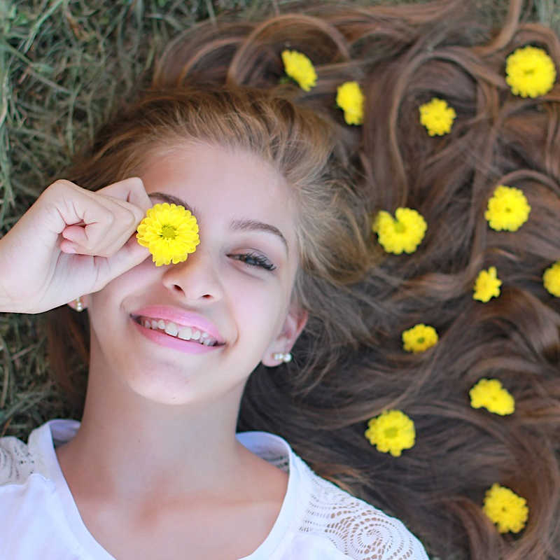 Girl with dandelions in her hair.