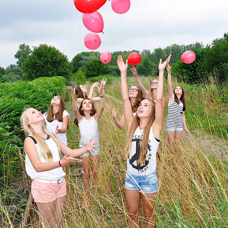 Gilrs outdoors with balloons